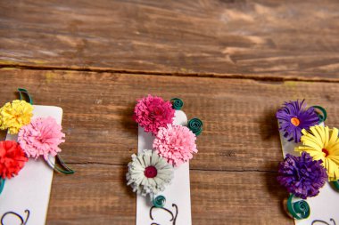 multicolored flowers on a wooden background.