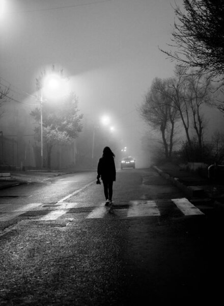 girl walking down the street at night