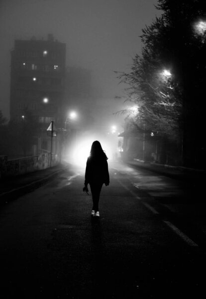 girl walking down the street at night