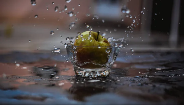 Apples in the water stream standing on the glass outdoors — Stock Photo, Image