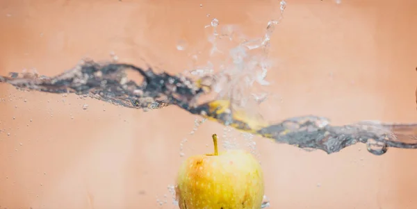 Apple dip in aquarium — Stock Photo, Image