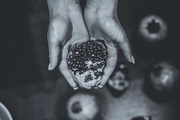 Fruto de granada en las manos de la mujer — Foto de Stock