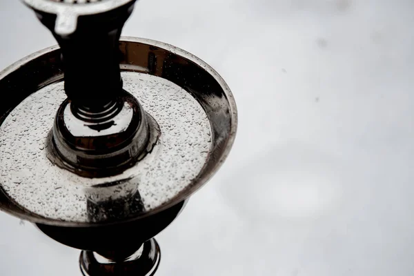 Big hookah for tobacco made of metal, glass and ceramics. Snowing. Snow background. White — Stock Photo, Image