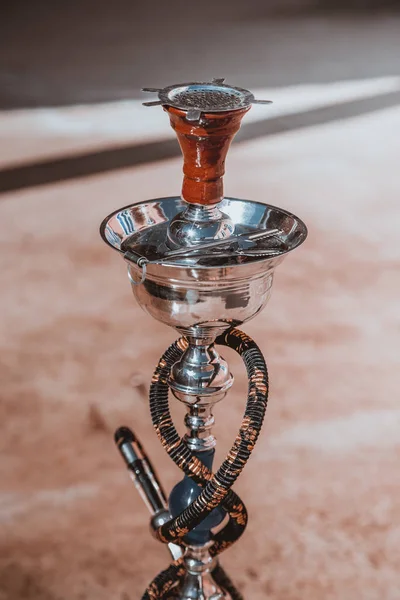 Big hookah for tobacco made of metal, glass and ceramics. Shine. Sunny day