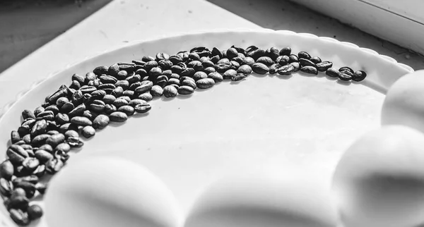 Coffee beans in moon shape on the white plate — Stock Photo, Image