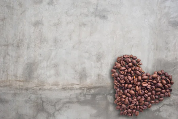 Granos de café en forma de corazón sobre fondo hermoso. Amor. Inscripción. Sobre fondo concreto . — Foto de Stock