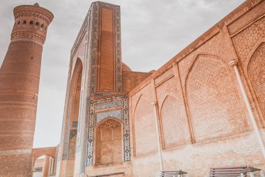 Poi Klyan Complex (12-14 century) in Bukhara, Uzbekistan. Kalyan Mosque and Kalyan or Kalon Minor (Great Minaret). Bukhara is World Heritage Site by UNESCO. Po-i Kalan (kalyan) clipart