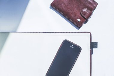 Boş defter, cep telefonu ve beyaz arka plan üzerinde bir cüzdan. . Metin için alan
