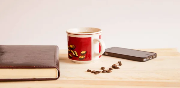 Mix of office supplies and gadgets on a wooden table background. — Stock Photo, Image