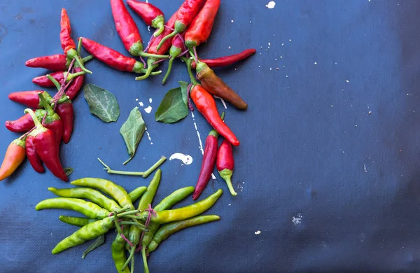 Red hot chili peppers açık havada. Karanlık kurulu arka plan üzerinde kırmızı ve yeşil biber