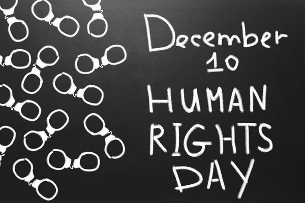 Η έννοια των ανθρωπίνων δικαιωμάτων: χειροπέδες και το κείμενο: ημέρα των ανθρωπίνων δικαιωμάτων που είναι γραμμένο στον μαυροπίνακα. — Φωτογραφία Αρχείου