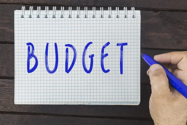 Hand writing on notepad: Budget Stock Image