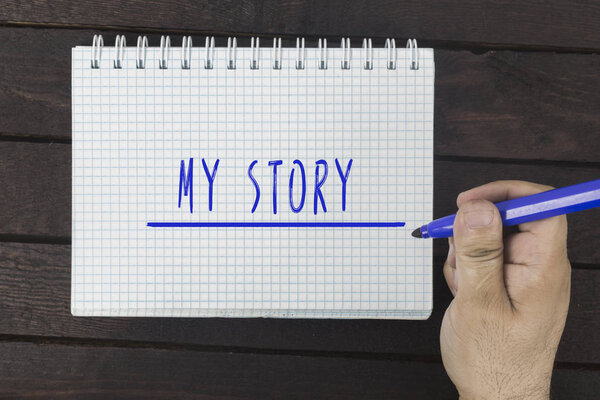 hand writing on notepad: My story