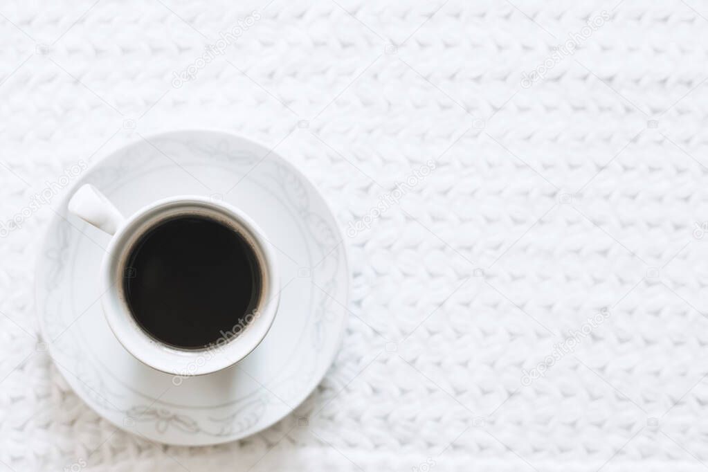 Morning coffee. A cup of coffee. Hot black coffee on the pure white knitted tablecloth