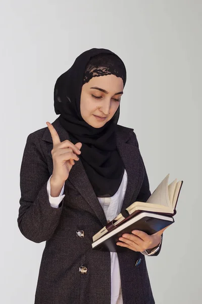 Pretty Muslim businesswoman in hijab holding stack of business documents, notepads and thinking - Good idea. Woman doing business in Islamic word, or Islamic countries — 스톡 사진