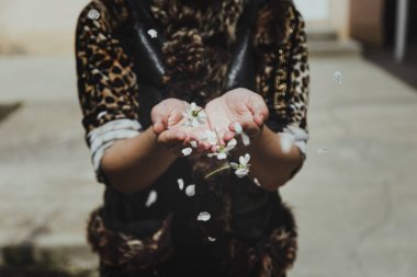Woman holds in hands first spring tree blossoms