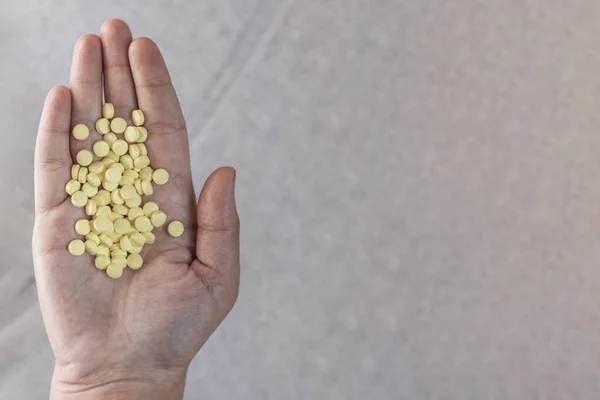 Woman Holding Yellow Pills Hand Top View — Stock Photo, Image