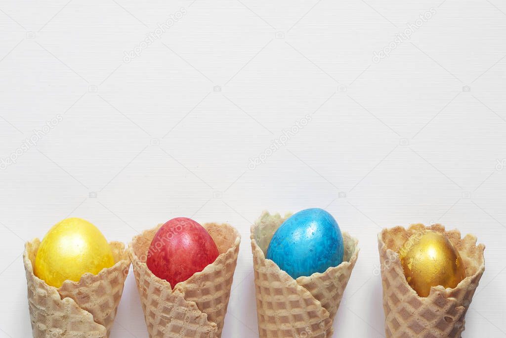 Happy easter concept. Easter festive background. Ice cream cone and bright colorful decorated easter eggs on the white background. Top view