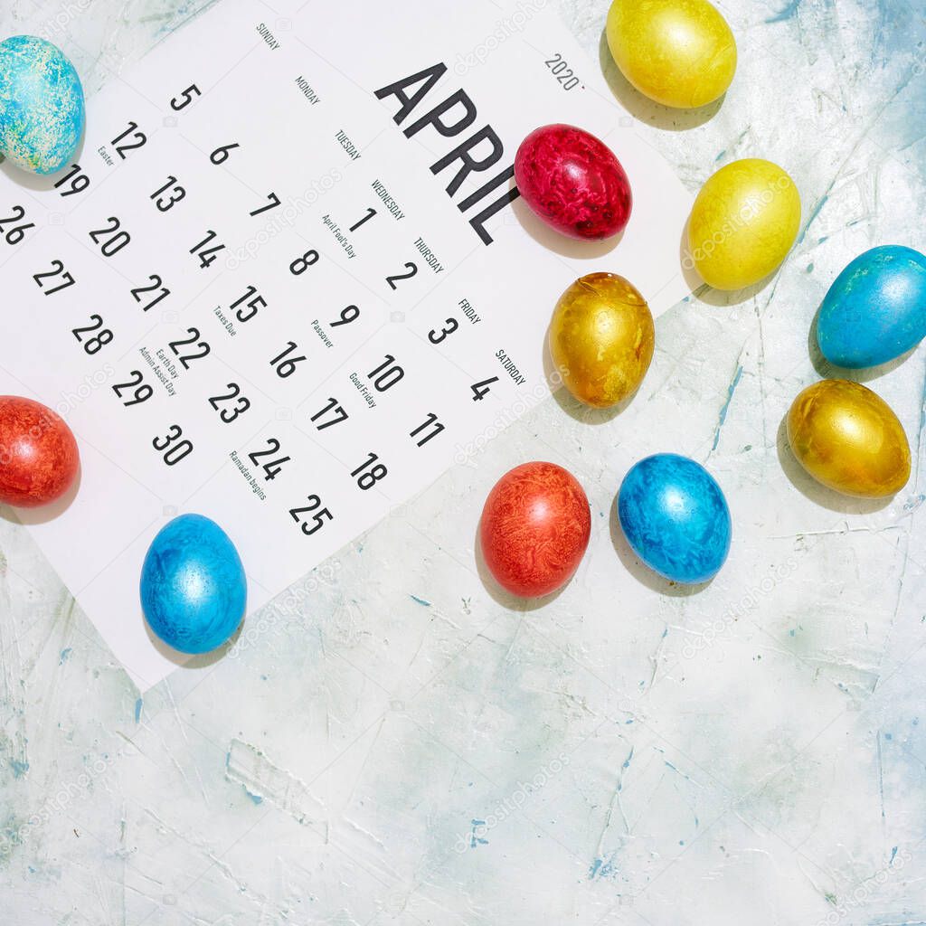 Monthly April 2020 calendar with colorful decorated Easter eggs. View from above. Top view. Easter holidays, festive, springtime concepts