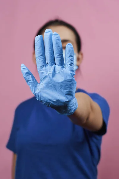 Woman showing stop hand-gesture. Stop coronavirus. Stop sign with hand. Stop spreading Covid-19 or coronavirus concepts. Time to stay home during virus infection spread