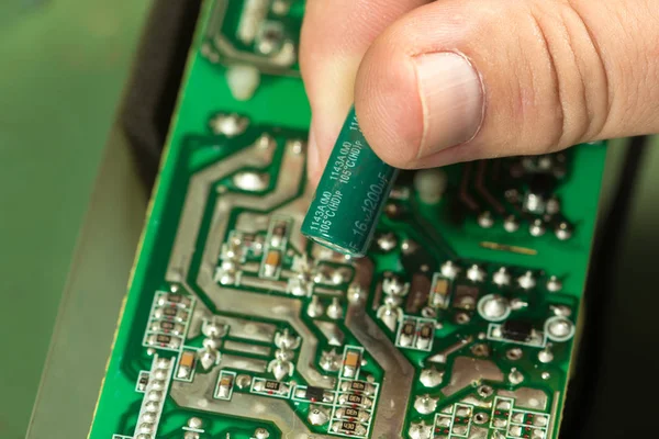 Replace capacitor in circuit board — Stock Photo, Image