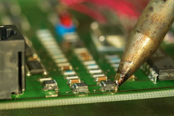 Repair  electronic circuit board with soldering iron — Stock Photo, Image