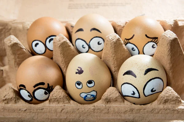 Six frightened egg faces in the brown panel