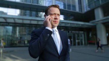İşadamı sokakta telefonda konuşurken bir takım