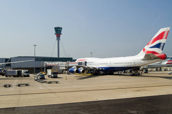 LONDON, UK - JUNE 9, 2016:  A British Airways jumbo jet at a stand at London Heathrow Airport Terminal 5 on a sunny Summer morning.  