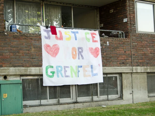 Hand drawn banner calling for Justice for Grenfell displayed on the balcony of a flat next to the Grenfell Tower block in which at least 80 people were killed in a fire, Kensington, London.