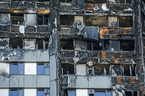 Close up view of the exterior of the Grenfell Tower block of flats in which at least 80 people lost their lives in a fire.  Remains of exterior cladding can be seen out the outside of the building, this is thought to have increased the spread of the