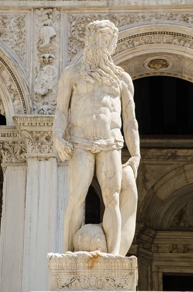 Statue of the Roman god of the sea - Neptune at the top of the Giants\' Staircase to the historic Doge\'s Palace in Venice, Italy. Sculpted by the Renaissance artist Jacopo Sansovino.