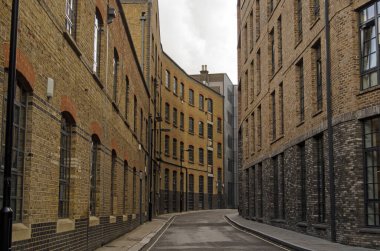 Historic, narrow street in Southwark, London.  Valentine Place has existed since the 18th century and was overtaken by the current warehouse and factory buildings in late Victorian times.  clipart