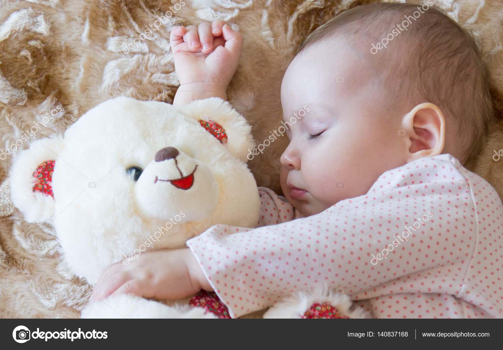 baby sleeping with teddy bear