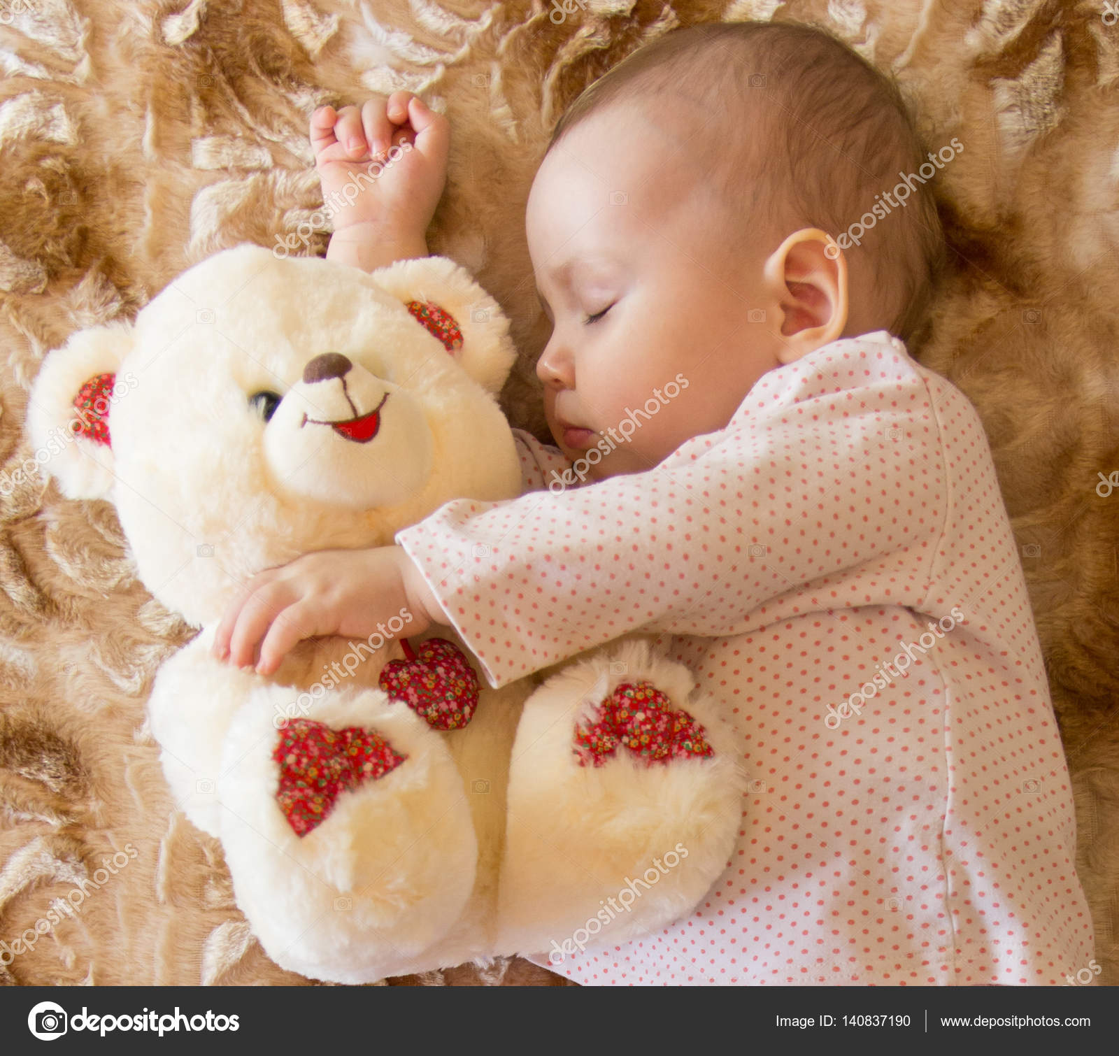 baby sleeping with teddy