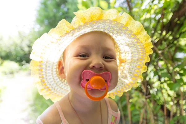 Cute baby with a pacifier in the sun — Stock Photo, Image