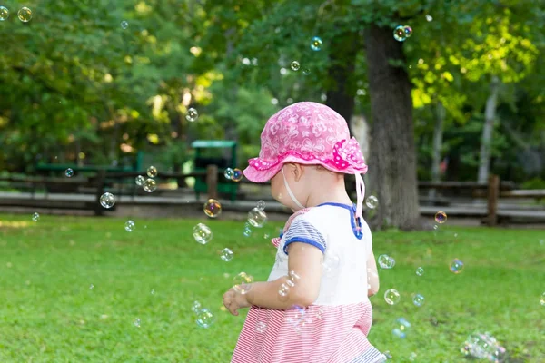 Portrait of a baby and soap bubbles — Stock Photo, Image