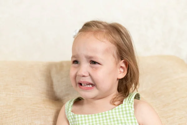 The baby is crying. the child is upset. tears on eyes — Stock Photo, Image