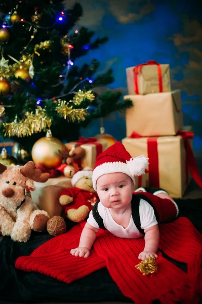 クリスマスのおとぎ話肖像画木下正月背景でサンタ クロースのようなを着ているかわいい赤ちゃん — ストック写真