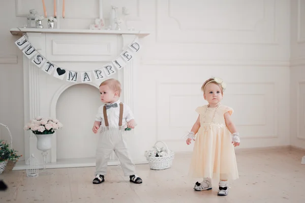 Two babies wedding - boy and girl dressed as bride and groom — Stock Photo, Image