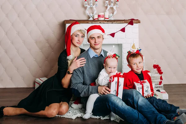 Retrato de familia amigable mirando a la cámara en la noche de Navidad — Foto de Stock