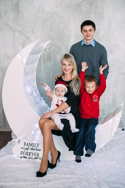 Portrait of friendly family looking at camera on Christmas evening — Stock Photo, Image