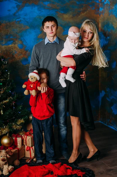 Portrait of friendly family looking at camera on Christmas evening — Stok Foto