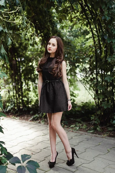Красивая молодая девушка в черном платье с длинными волосами, супер мило — стоковое фото