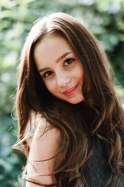 Beautiful young girl in black dress with long hair, super cute a — Stock Photo, Image