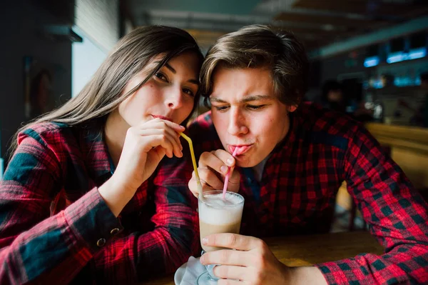 Um grupo de jovens amigos numa cafetaria. Jovens homens e mulheres que se encontram em um café se divertindo e bebendo café. Estilo de vida, amizade e conceitos de vida urbana . — Fotografia de Stock