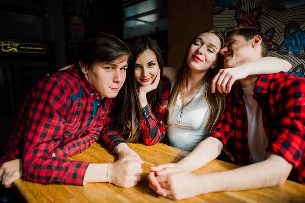 Un gruppo di giovani amici che frequentano una caffetteria. Giovani uomini e donne che si incontrano in un caffè per divertirsi e bere caffè. Stile di vita, amicizia e concetti di vita urbana . — Foto Stock