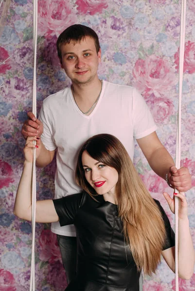 Portrait of young couple in love posing at studio dressed in classic clothes — Stock Photo, Image