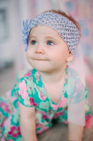 Adorável menina rindo, sorrindo, rastejando e brincando no estúdio vestindo vestido de hortelã — Fotografia de Stock