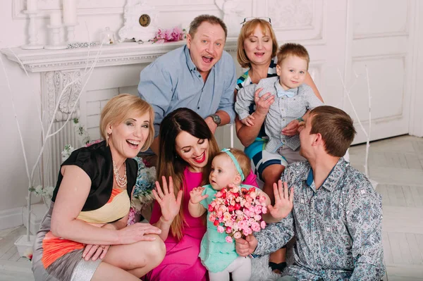 Extended Family Relaxing Together at the fireplace — Stock Photo, Image